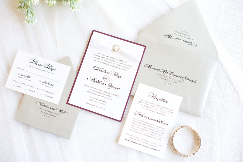 elegant formal layered wedding invitation with satin ribbon and rhinestone crystal embellishment in white, silver shimmer, burgundy wine maroon