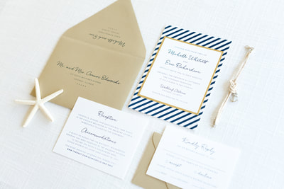 modern nautical wedding invitation layered with navy blue stripe pattern, gold foil, gold shimmer, and white