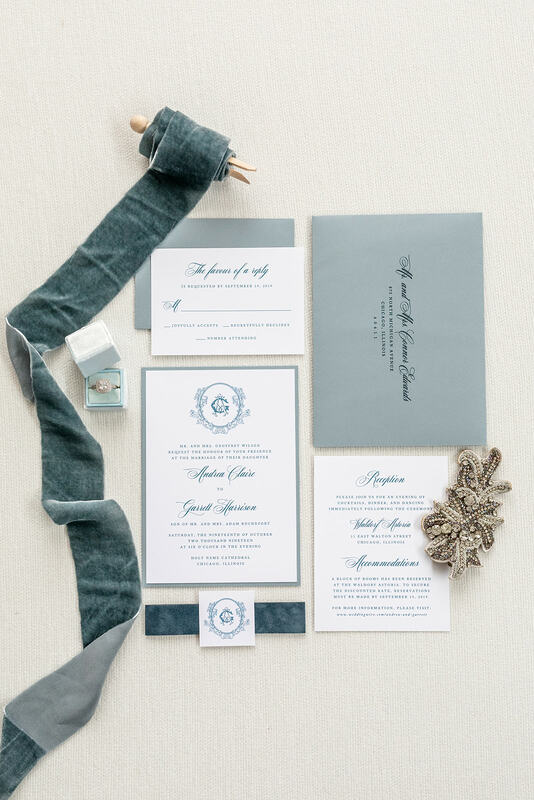 elegant & formal wedding invitation with velvet ribbon belly band band in white, dusty blue, french blue, and vintage ornate filigree monogram crest