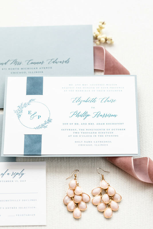 elegant & formal wedding invitation with velvet ribbon band in white, dusty blue, french blue, and floral branch fern foliage monogram crest