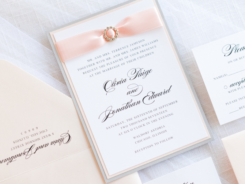 elegant formal luxury layered wedding invitation with satin ribbon and rhinestone crystal embellishment in white, silver, and blush shimmer