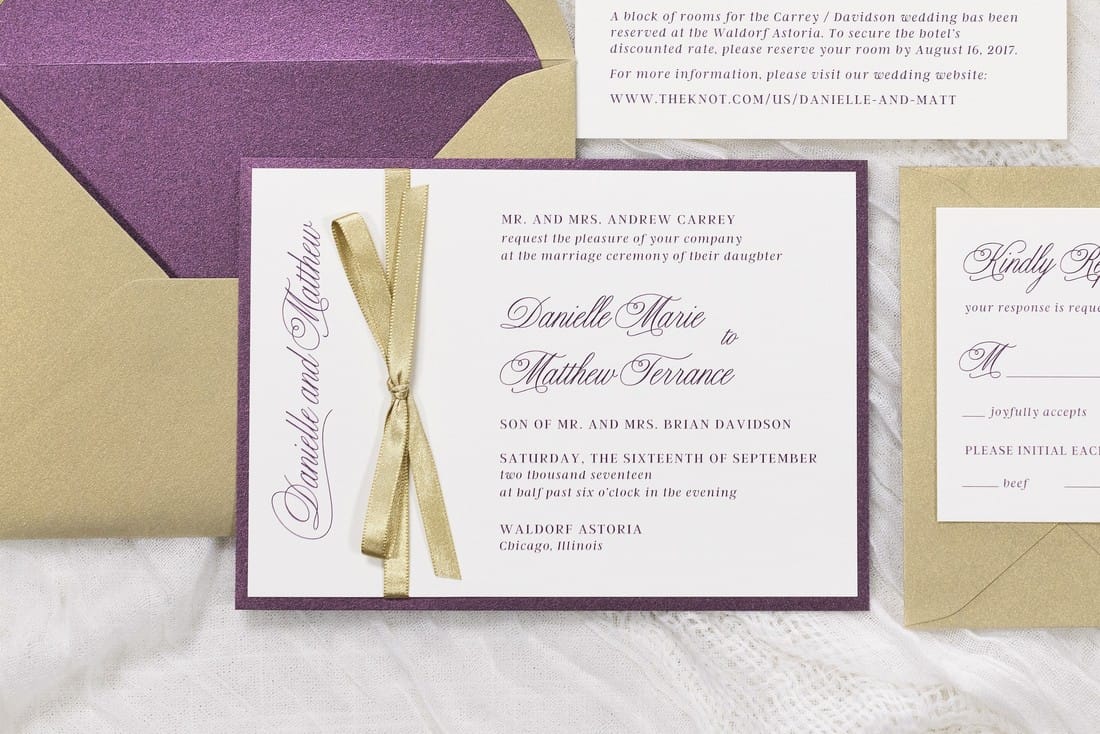 elegant and formal wedding invitation in gold shimmer, merlot, ivory with a gold ribbon bow embellishment and envelope liner