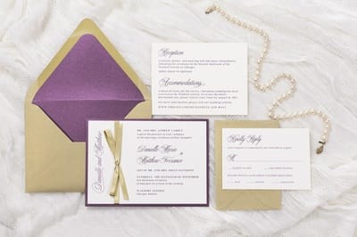 elegant and formal wedding invitation in gold shimmer, merlot, ivory with a gold ribbon bow embellishment and envelope liner