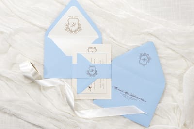 elegant and formal pale, light blue, serenity blue and opal shimmer wedding invitation with botanical laurel formal wedding monogram crest - chicago wedding invitations