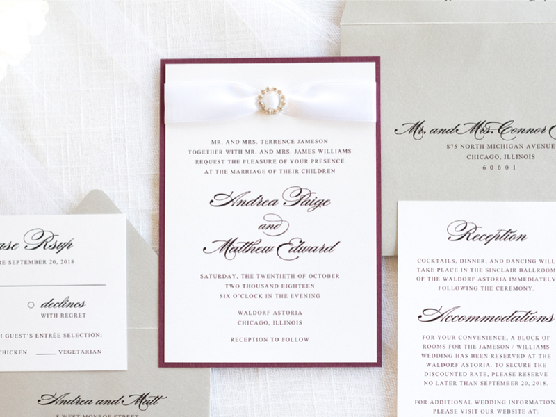 elegant formal layered wedding invitation with satin ribbon and rhinestone crystal embellishment in white, silver shimmer, burgundy wine maroon