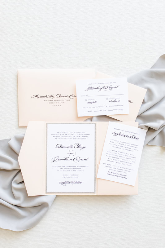 elegant formal white silver glitter and blush metallic shimmer pocketfold wedding invitation suite with satin ribbon belly band monogram