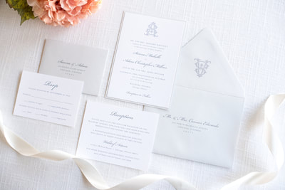 elegant & formal wedding invitation with monogram crest design in white, light dusty blue cool grey