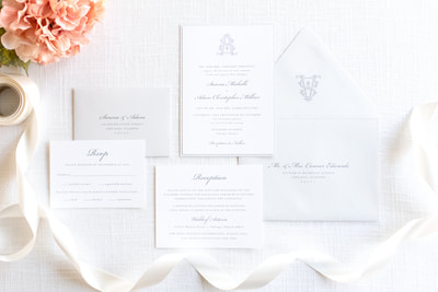 elegant & formal wedding invitation with monogram crest design in white, light dusty blue cool grey