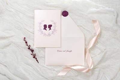 elegant and formal folding blush and opal shimmer wedding invitation with cameo silhouette wax seal and belly band