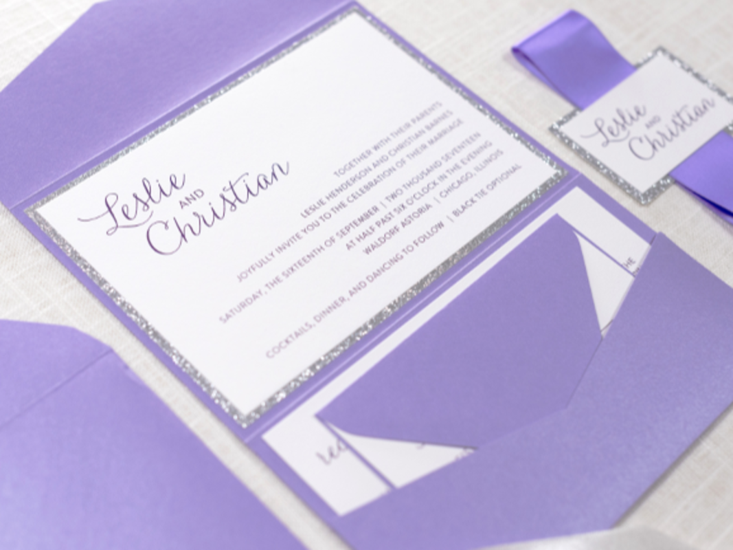 ELEGANT AND FORMAL WHITE, SILVER GLITTER AND PURPLE SHIMMER POCKETFOLD WEDDING INVITATION WITH SATIN RIBBON BELLY BAND AND MONOGRAM